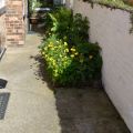 Small flower bed next tot the door